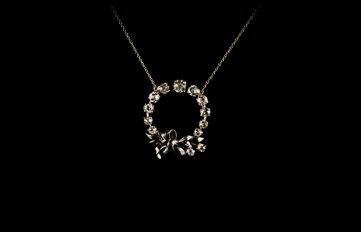 18ct gold circular old cut diamond set pendant with bow design