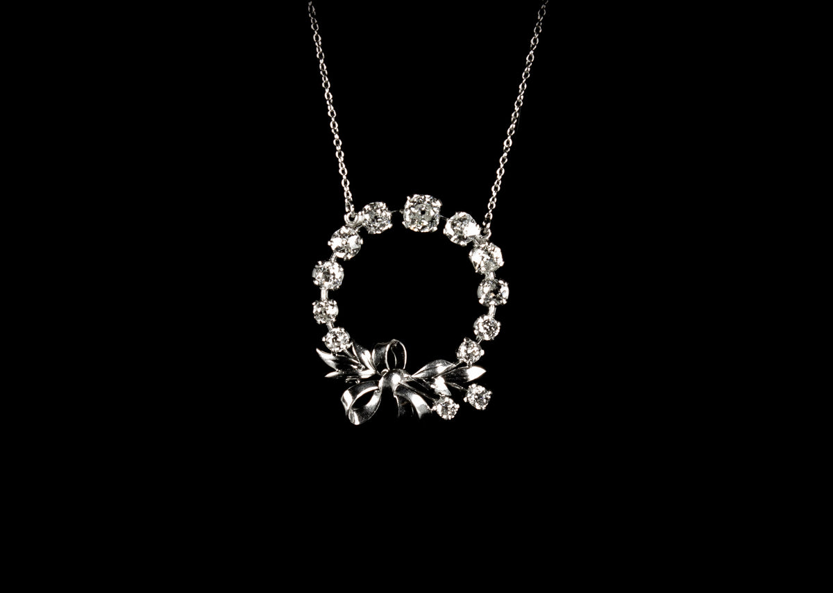 18ct gold circular old cut diamond set pendant with bow design