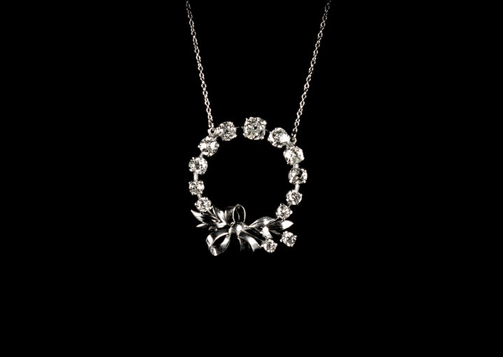 18ct gold circular old cut diamond set pendant with bow design