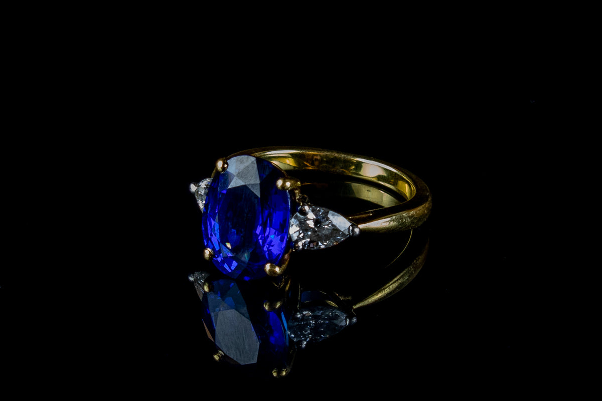 An Impressive 18ct Gold Oval Cut  4.96ct Sapphire And Pear Cut Diamond Three Stone Ring