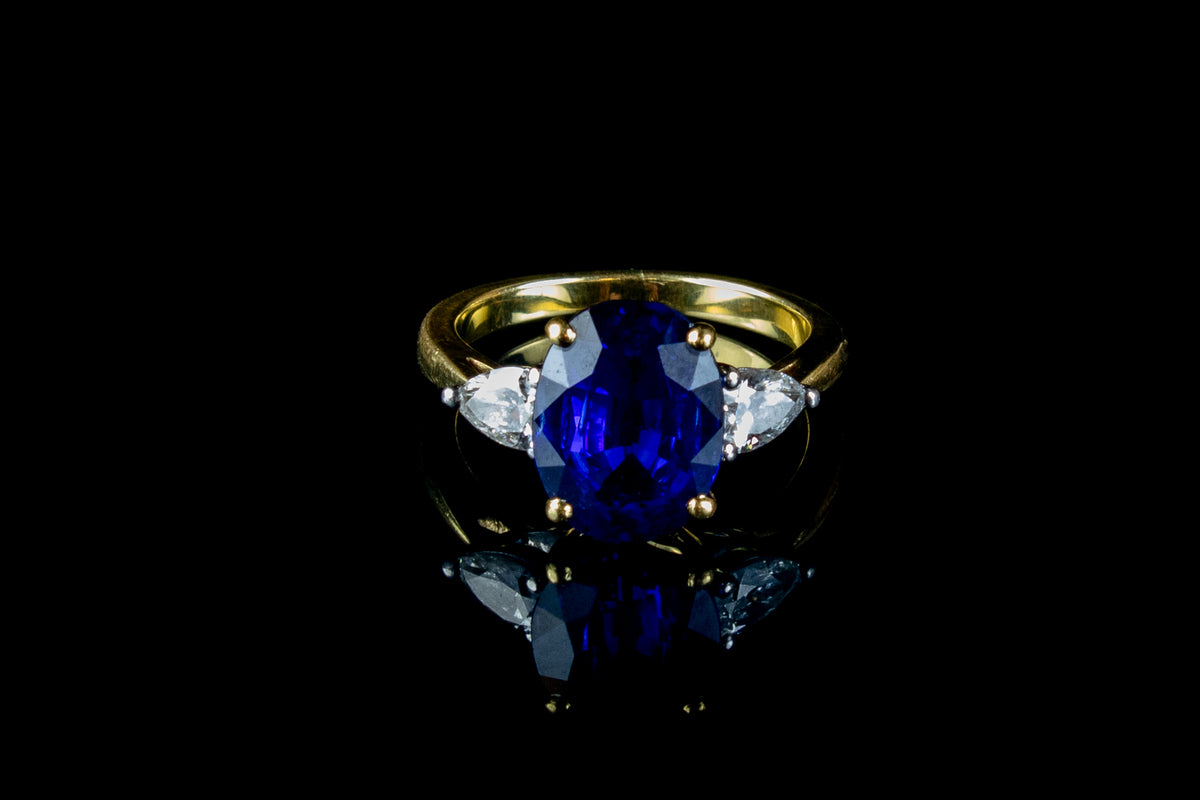 An Impressive 18ct Gold Oval Cut  4.96ct Sapphire And Pear Cut Diamond Three Stone Ring