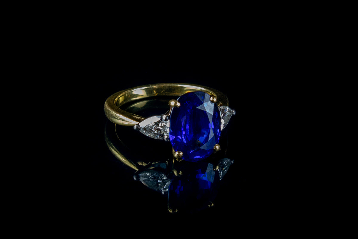 An Impressive 18ct Gold Oval Cut  4.96ct Sapphire And Pear Cut Diamond Three Stone Ring