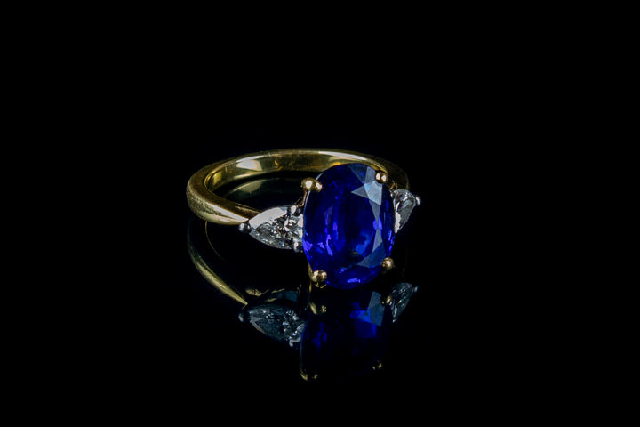 An Impressive 18ct Gold Oval Cut  4.96ct Sapphire And Pear Cut Diamond Three Stone Ring
