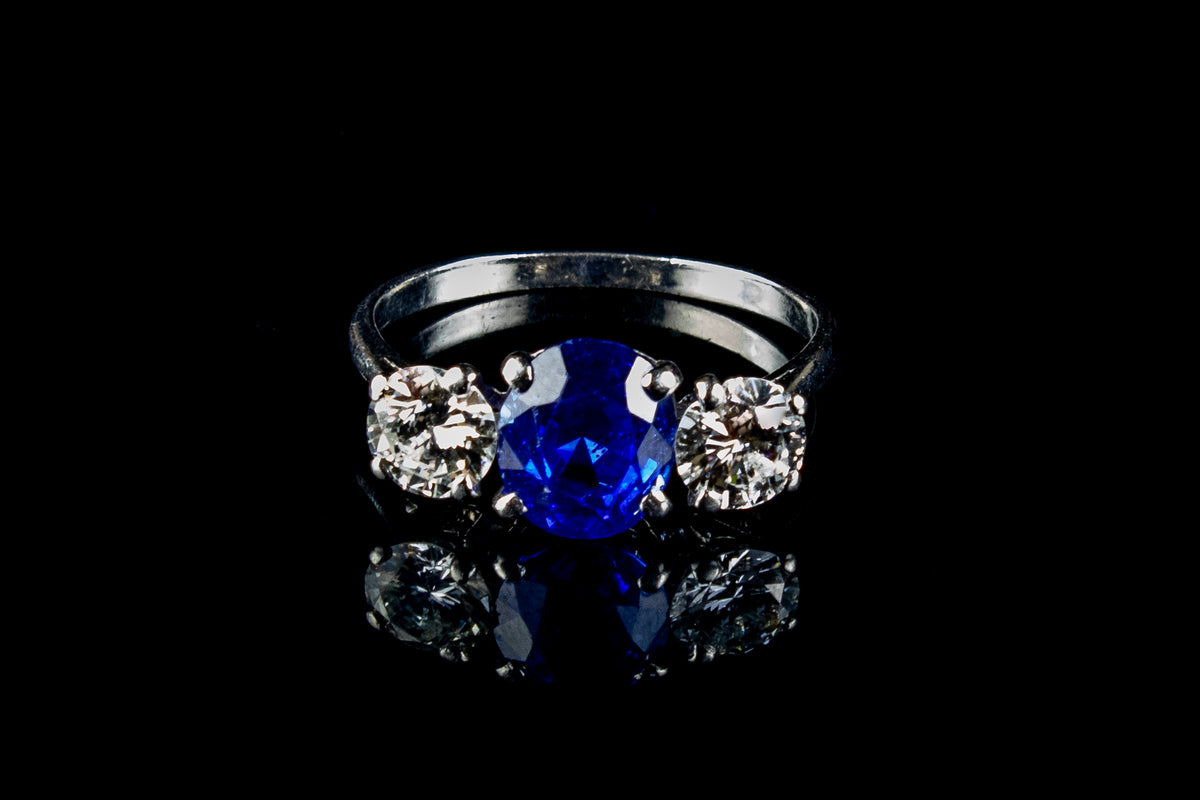 Platinum Mounted Three Stone Diamond and 3.04ct Sapphire Ring