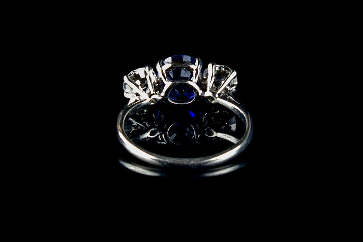Platinum Mounted Three Stone Diamond and 3.04ct Sapphire Ring