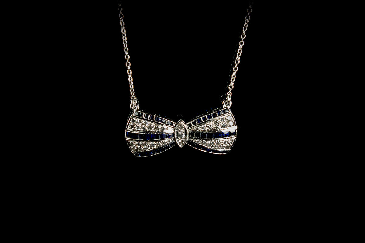 18ct White Gold Sapphire and Diamond set Bow Pendant, London 1990