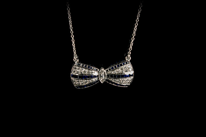 18ct White Gold Sapphire and Diamond set Bow Pendant, London 1990
