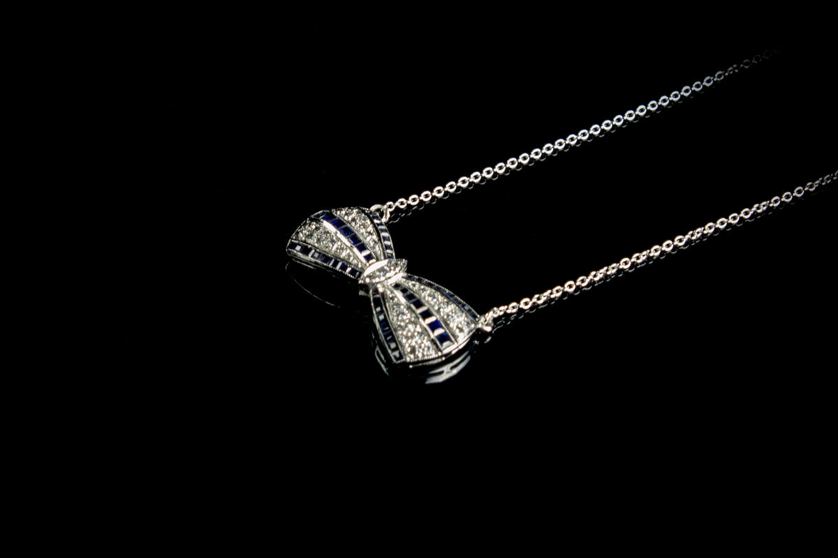 18ct White Gold Sapphire and Diamond set Bow Pendant, London 1990