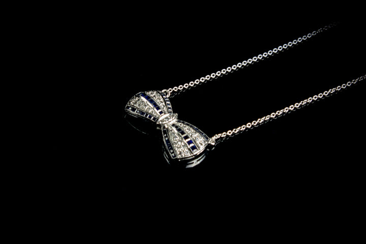 18ct White Gold Sapphire and Diamond set Bow Pendant, London 1990