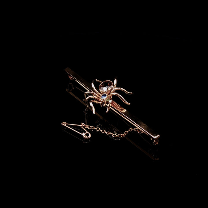 Art Deco 9ct Gold Spider Bar Brooch with Brown Zircon and Sapphire by Saunders & Shepherd, Circa 1930