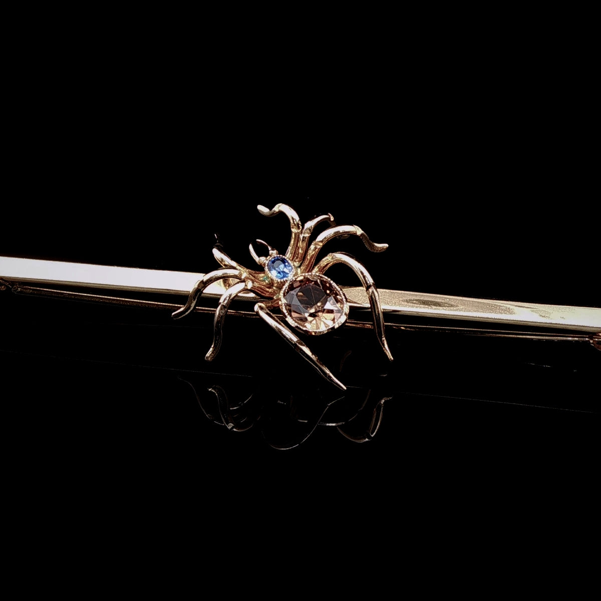 Art Deco 9ct Gold Spider Bar Brooch with Brown Zircon and Sapphire by Saunders & Shepherd, Circa 1930